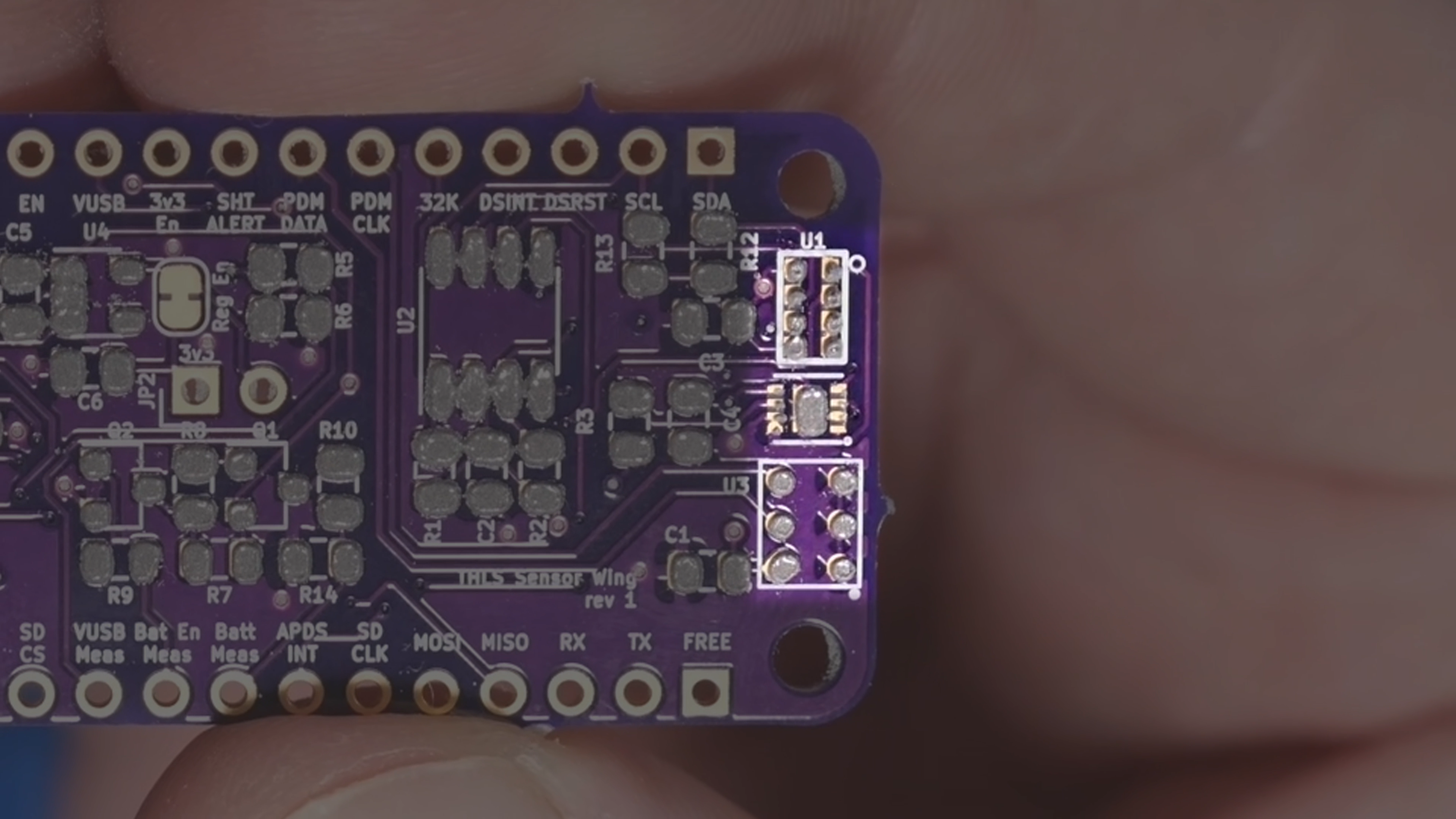 Close-up of solder paste on the fine-pitch component pads of a Bald SENSE revision 1 PCB.